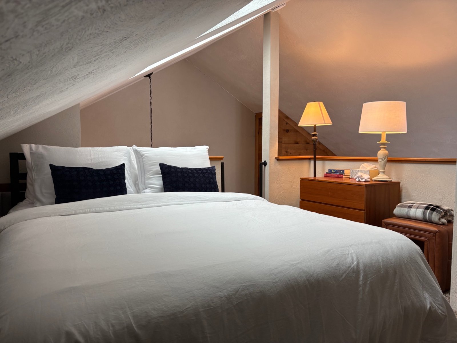 Cozy loft bedroom with warm lighting at Arcadia Mountainside