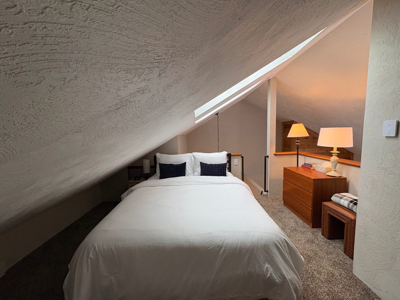 Another angle-cozy loft bedroom with warm lighting at Arcadia Mountainside